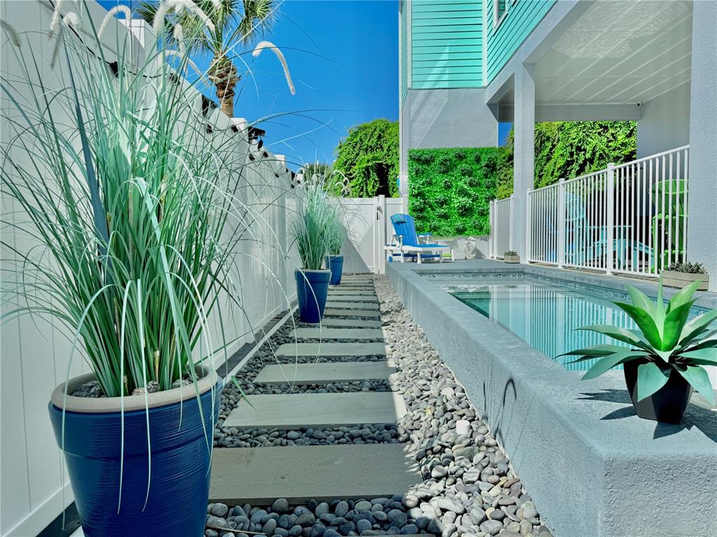 304 North 7th Street Flagler Beach, FL 32136 - Photo 64 of 89 a view of a house with a yard and potted plants