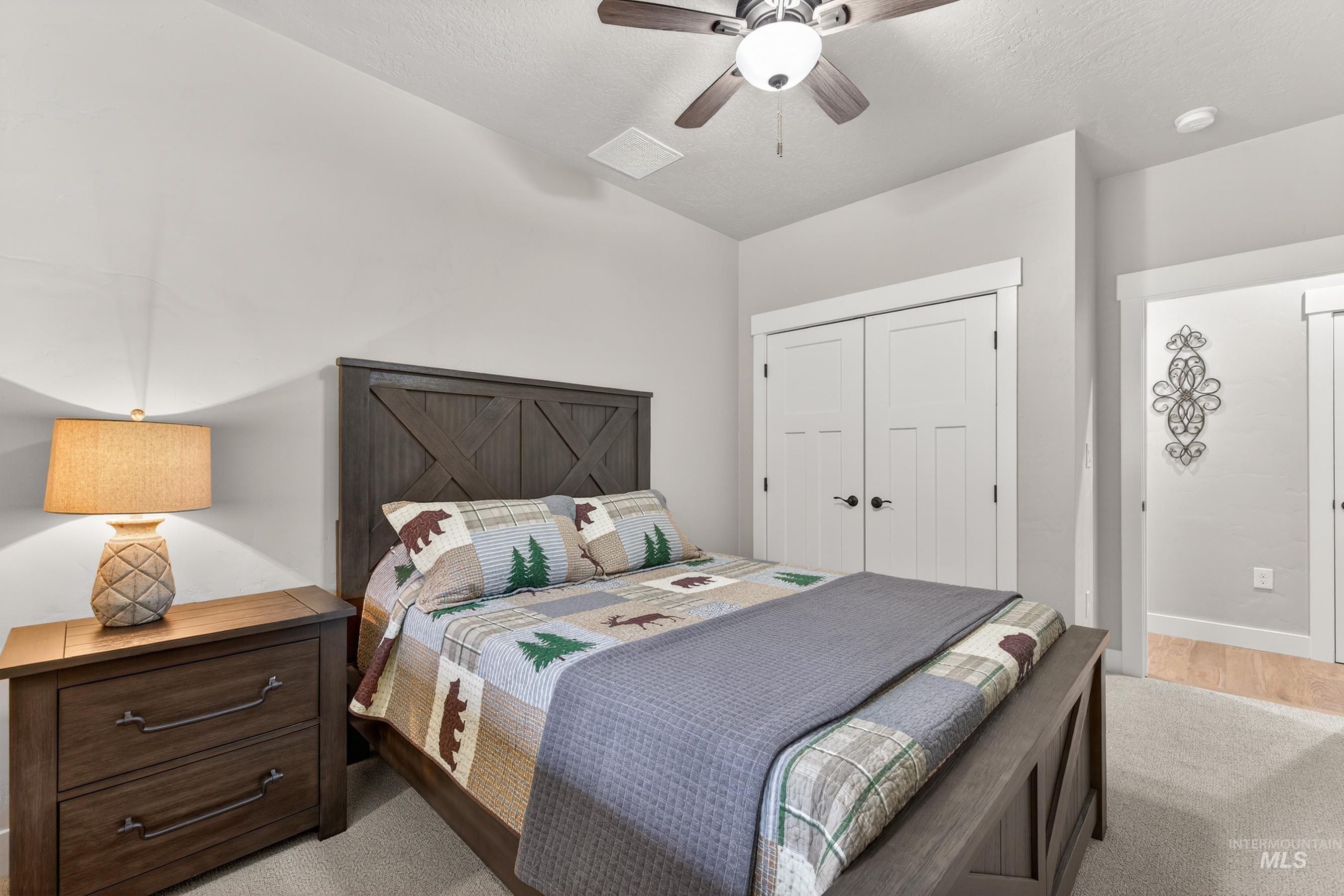 10191 Timberrim Drive Cascade, ID 83611 - Photo 22 of 44 Bedroom with ceiling fan, a closet, and a textured ceiling