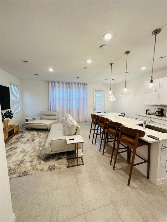 646 Longboat Drive Davenport, FL 33896 - Photo 1 of 41 a kitchen with a sink dining table and chairs