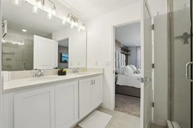 a en suite bathroom with a double sink and mirror