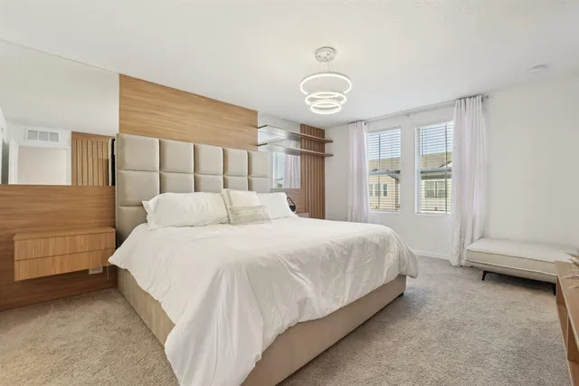 a spacious bedroom with a bed and a window