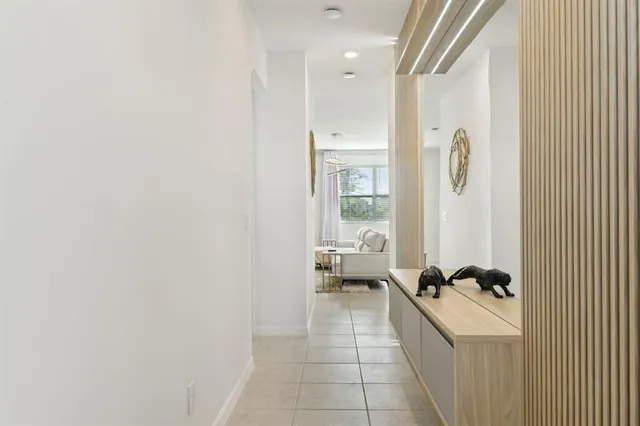 a hallway with a couch and a dresser next to a window