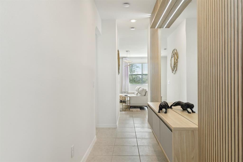 646 Longboat Drive Davenport, FL 33896 - Photo 20 of 41 a hallway with a couch and a dresser next to a window