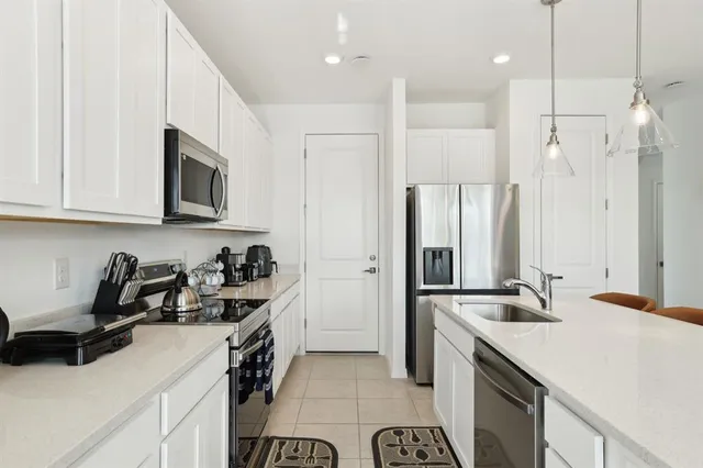 a kitchen with a sink a refrigerator and a stove