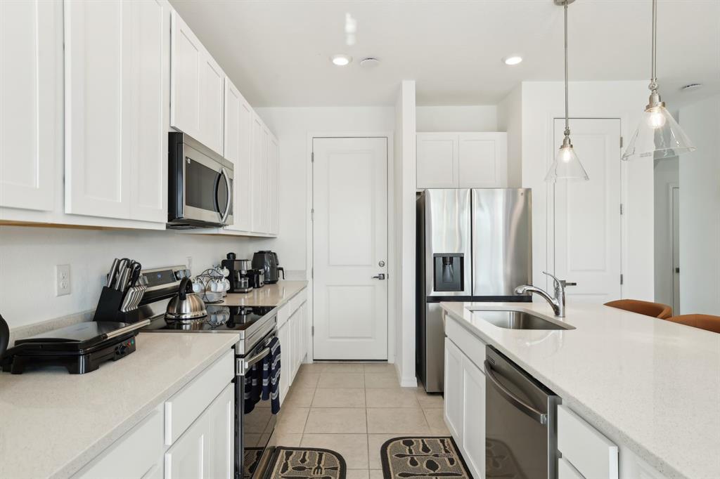 646 Longboat Drive Davenport, FL 33896 - Photo 21 of 41 a kitchen with a sink a refrigerator and a stove