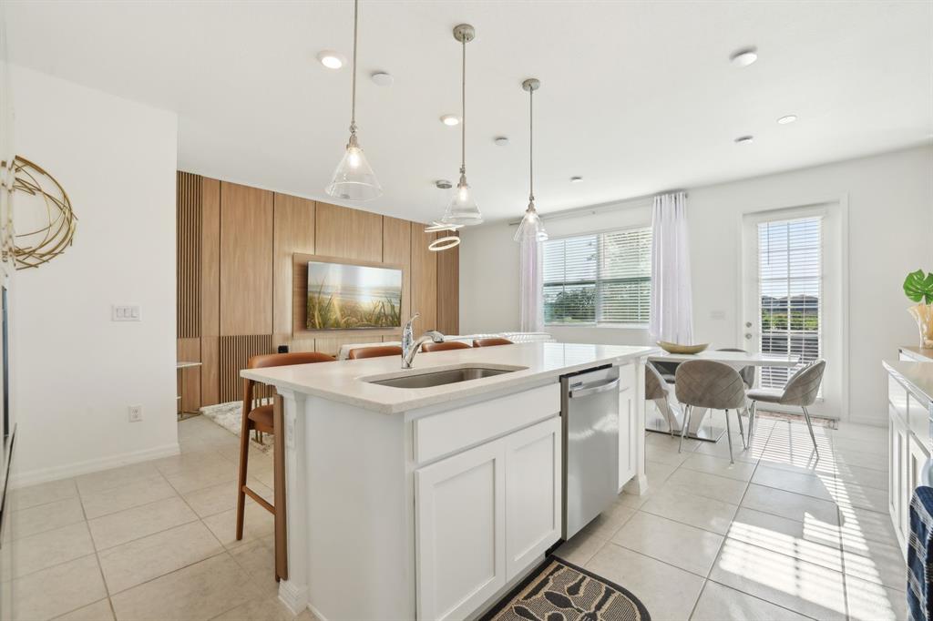 646 Longboat Drive Davenport, FL 33896 - Photo 22 of 41 a kitchen with a sink and chairs