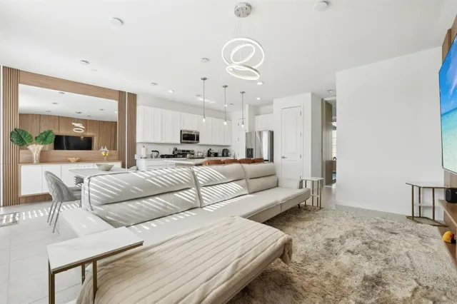 a living room with furniture and kitchen view