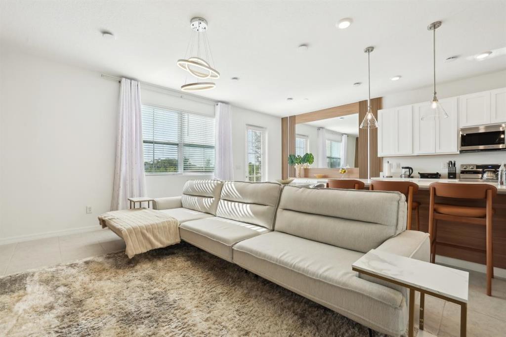 646 Longboat Drive Davenport, FL 33896 - Photo 32 of 41 a living room with furniture and a large window