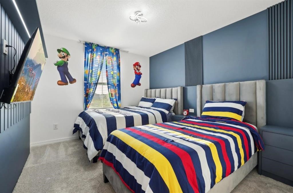 646 Longboat Drive Davenport, FL 33896 - Photo 35 of 41 a bedroom with two beds and a closet