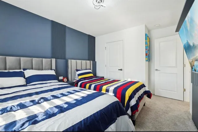 a bedroom with two beds and a lamp