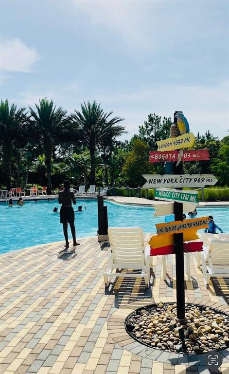 646 Longboat Drive Davenport, FL 33896 - Photo 4 of 41 a view of a swimming pool with a patio and a yard