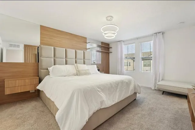 a spacious bedroom with a bed and a window