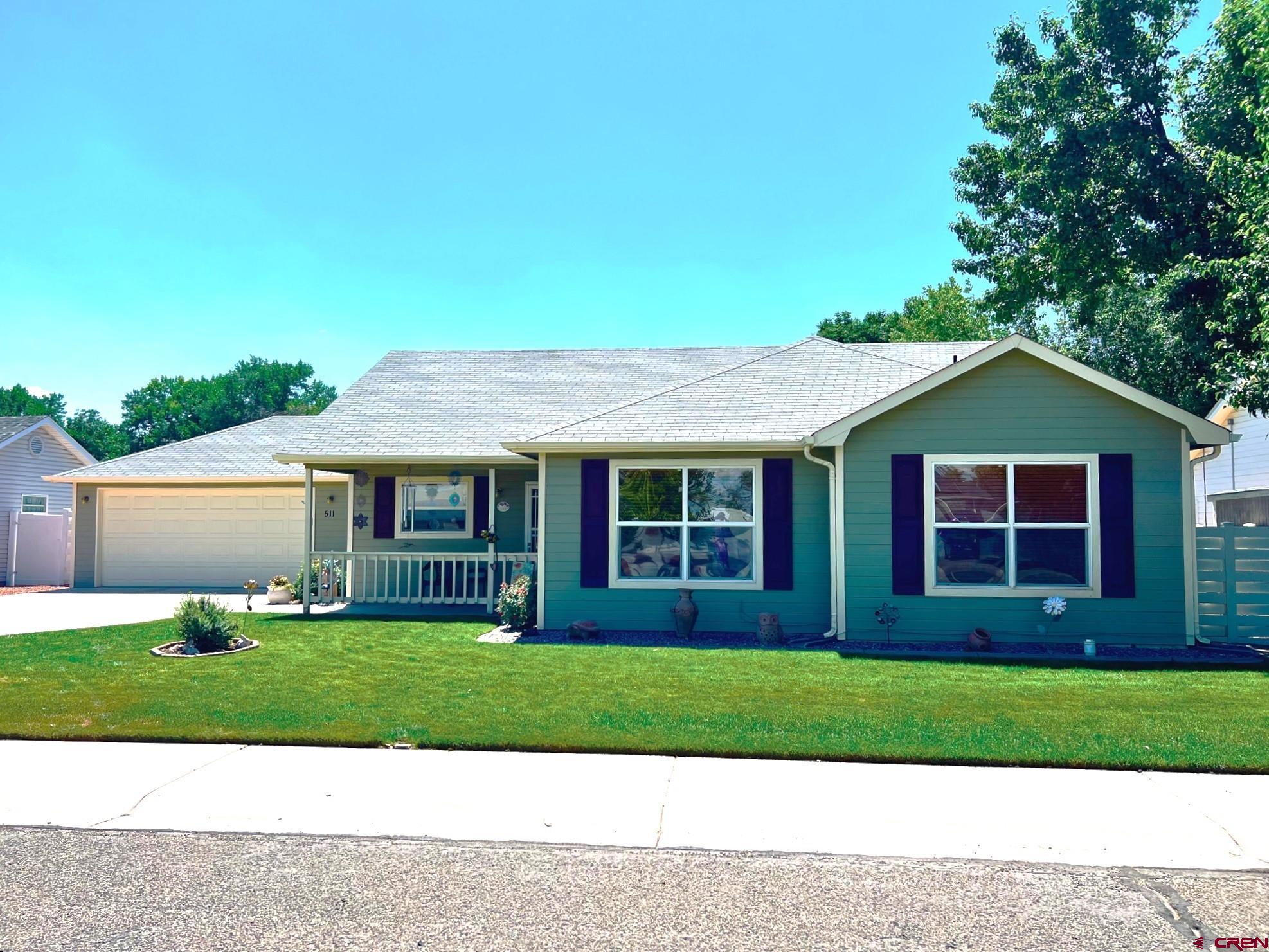 511 Hazel Circle Fruita, CO 81521 - Photo 1 of 24 a front view of a house with a yard
