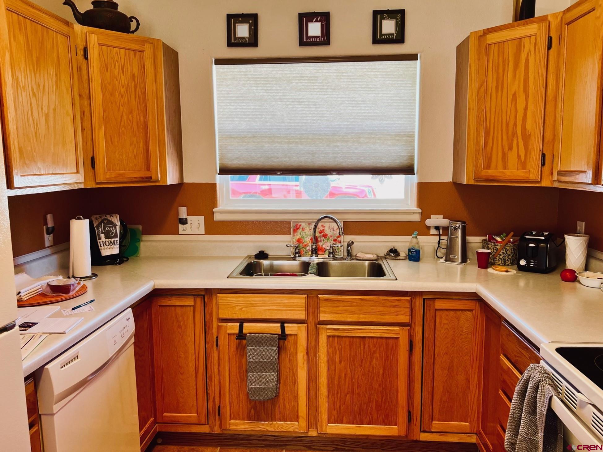 511 Hazel Circle Fruita, CO 81521 - Photo 12 of 24 a kitchen with stainless steel appliances granite countertop a sink stove and cabinets