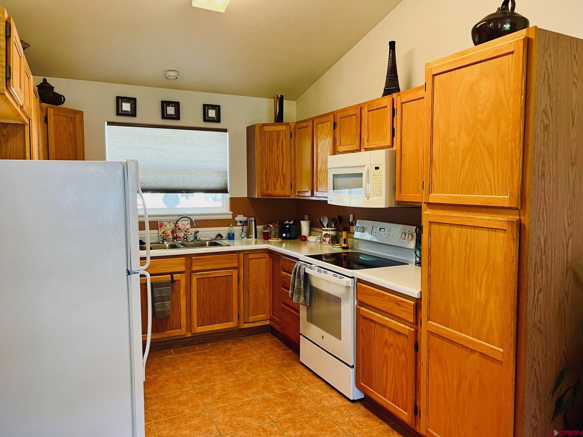511 Hazel Circle Fruita, CO 81521 - Photo 13 of 24 a kitchen with stainless steel appliances granite countertop a refrigerator and a stove