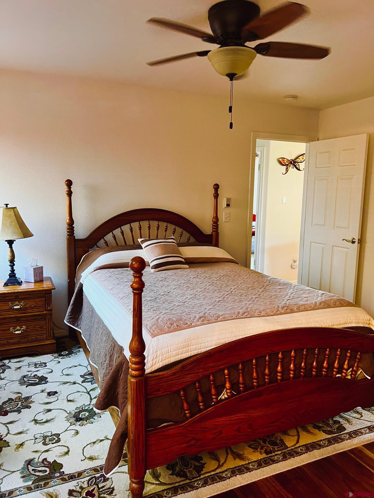 511 Hazel Circle Fruita, CO 81521 - Photo 15 of 24 a bedroom with a bed and a dresser