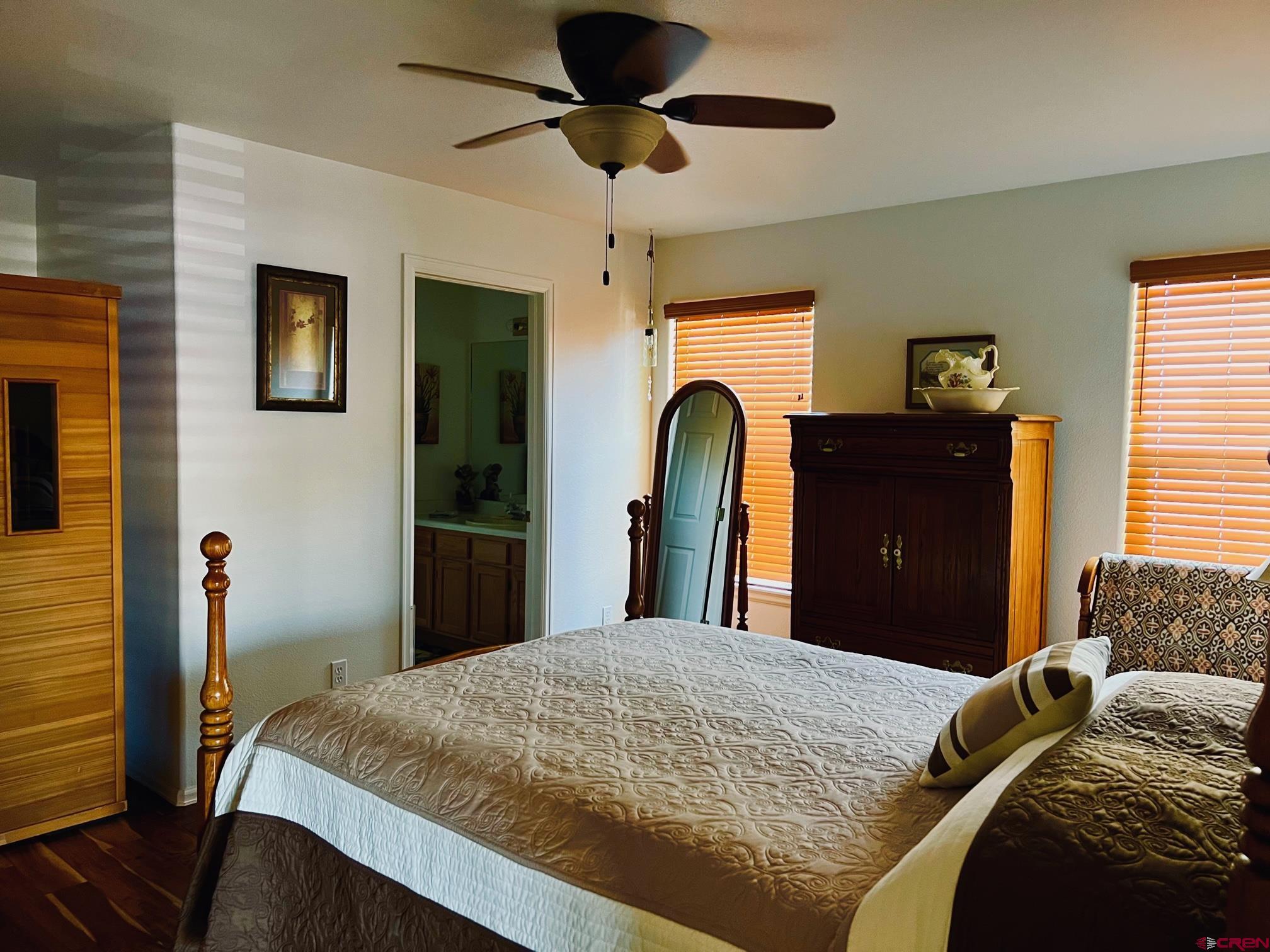 511 Hazel Circle Fruita, CO 81521 - Photo 18 of 24 a bed room with a bed and a chandelier