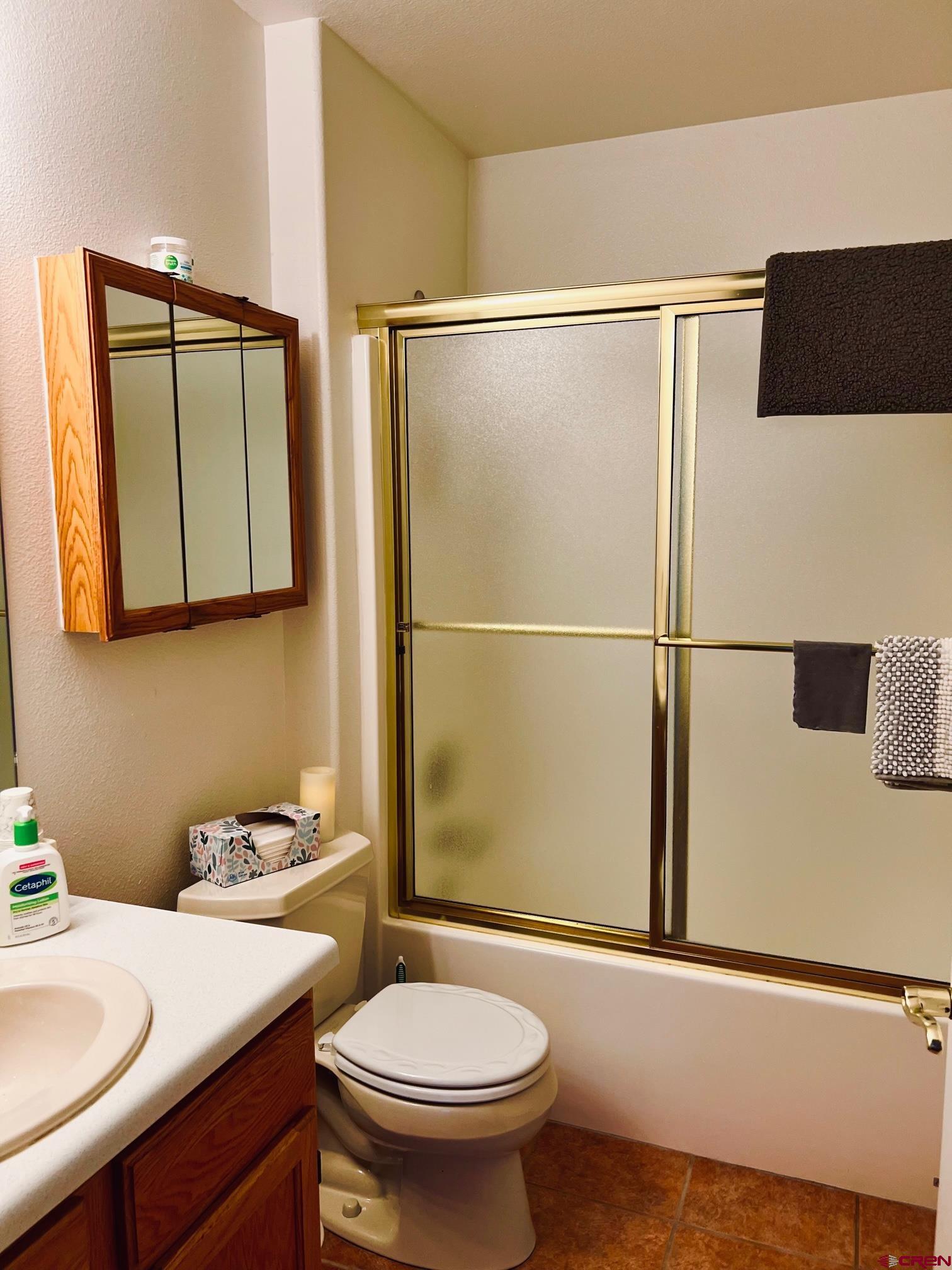 511 Hazel Circle Fruita, CO 81521 - Photo 22 of 24 a bathroom with a sink a toilet and a shower