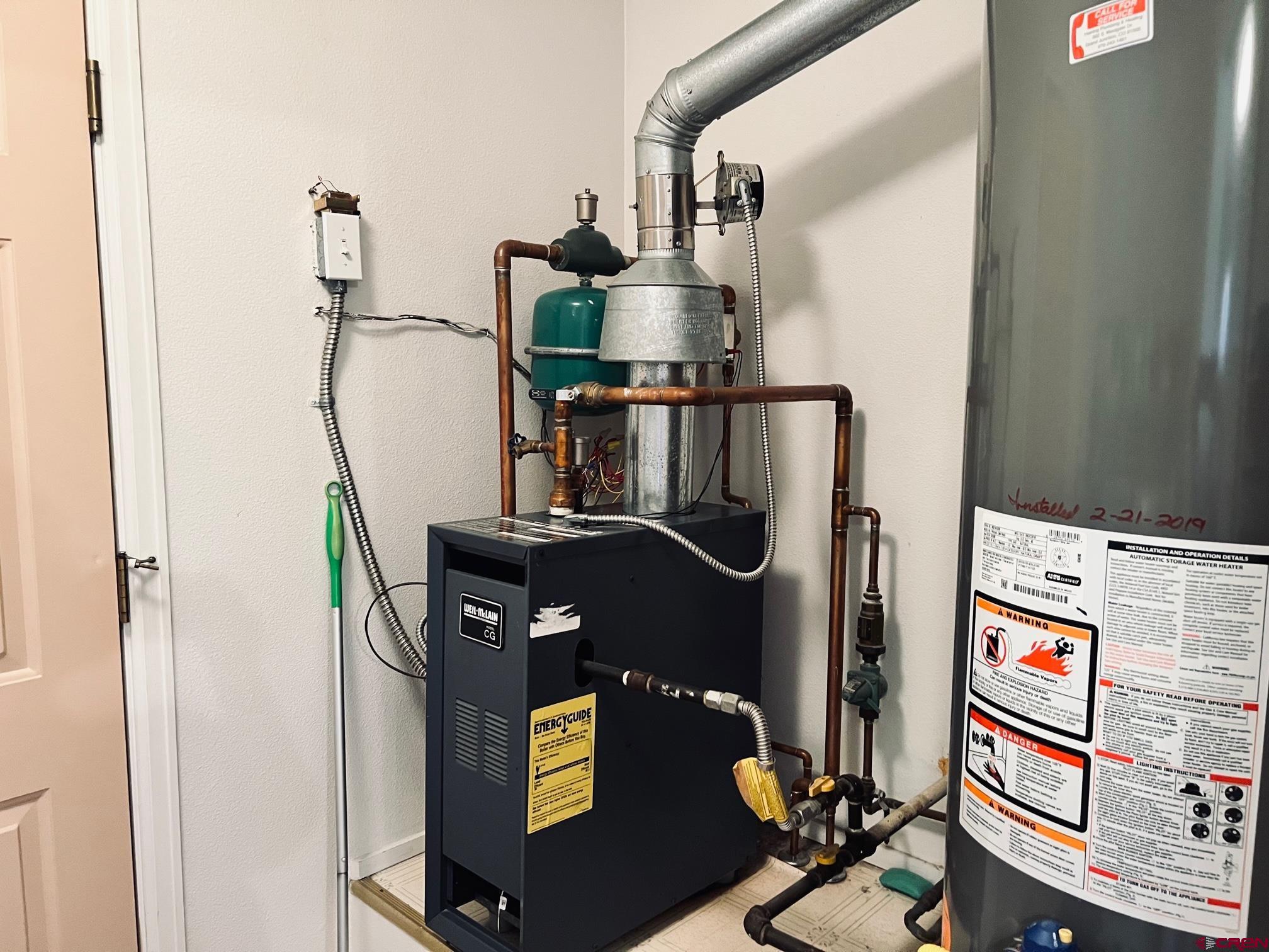 511 Hazel Circle Fruita, CO 81521 - Photo 23 of 24 a picture of water heater room with wooden floor
