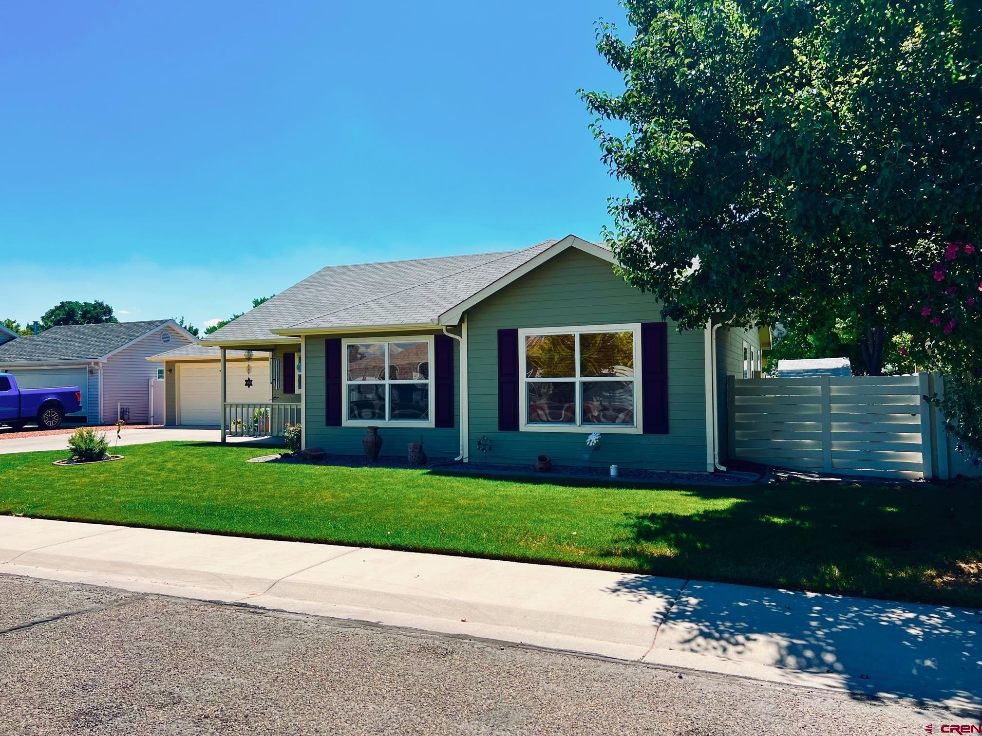 511 Hazel Circle Fruita, CO 81521 - Photo 3 of 24 a front view of a house with a yard and garage