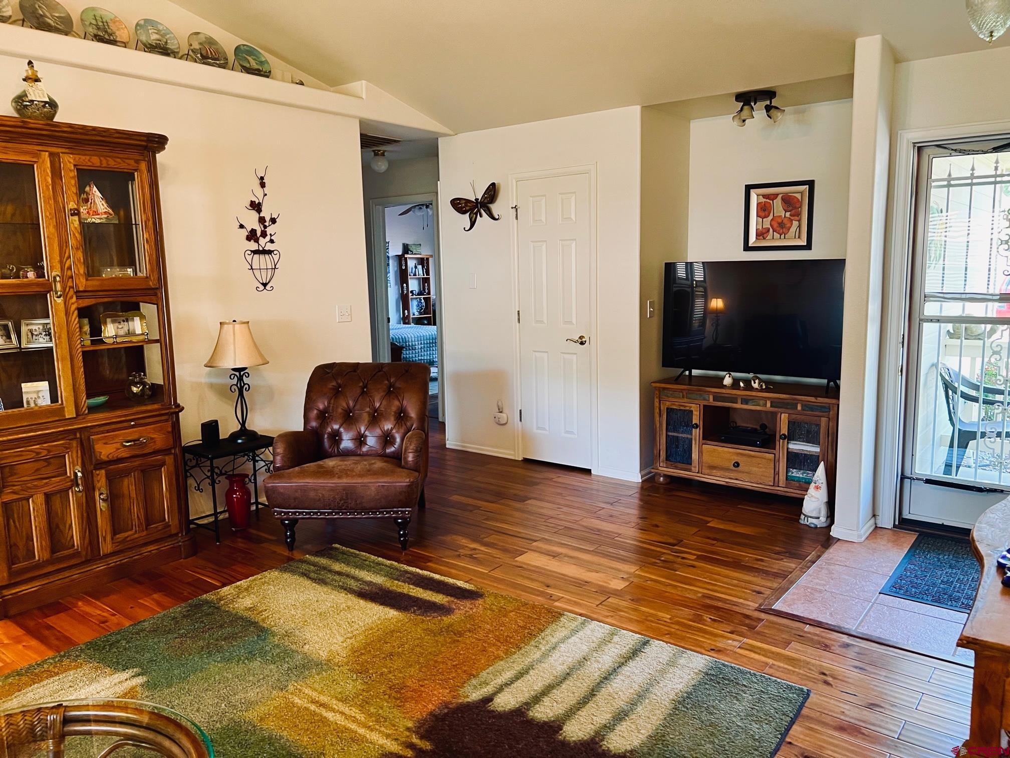 511 Hazel Circle Fruita, CO 81521 - Photo 9 of 24 a living room with furniture and a flat screen tv