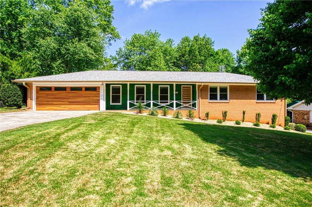 6797 Ramundo Drive Northwest Peachtree Corners, GA 30360 - Photo 1 of 1 a front view of house with yard and green space