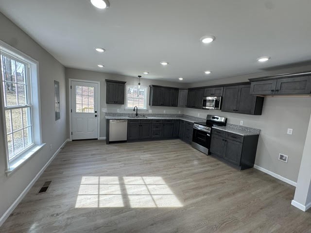 1267 Higginbotham Road McMinnville, TN 37110 - Photo 13 of 13 a large kitchen with a large counter top stainless steel appliances and cabinets