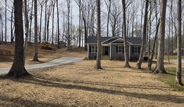 1267 Higginbotham Road McMinnville, TN 37110 - Photo 3 of 13 a house with trees in front of it