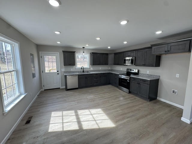 1267 Higginbotham Road McMinnville, TN 37110 - Photo 5 of 13 a large kitchen with stainless steel appliances granite countertop a stove sink and cabinets