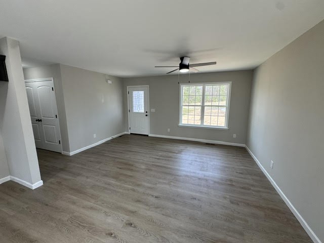 1267 Higginbotham Road McMinnville, TN 37110 - Photo 6 of 13 an empty room with wooden floor and windows