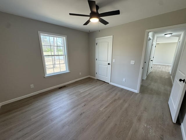 1267 Higginbotham Road McMinnville, TN 37110 - Photo 7 of 13 a view of empty room with wooden floor and fan