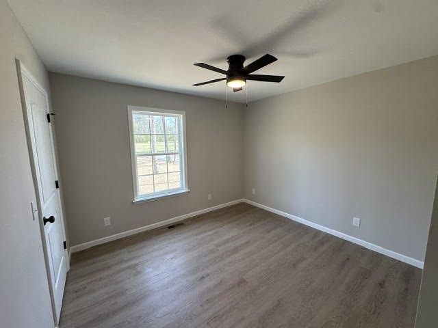 1267 Higginbotham Road McMinnville, TN 37110 - Photo 10 of 13 an empty room with wooden floor fan and windows
