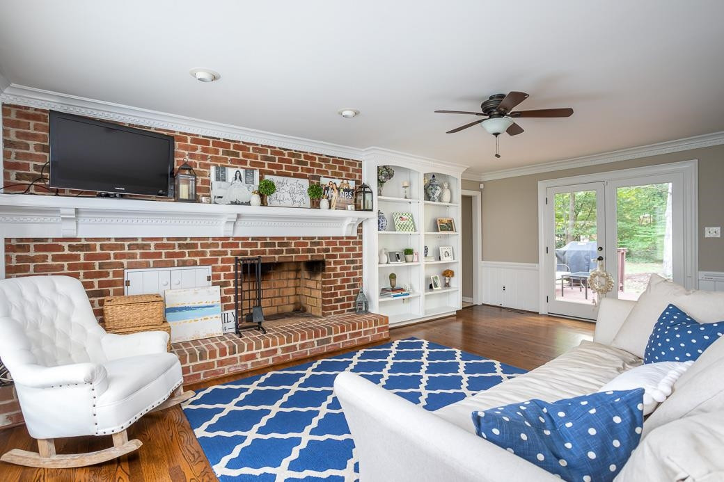8716 Mariner Drive Raleigh, NC 27615 - Photo 5 of 26 Hardwood floors, feature fireplace, and lots of natural light.