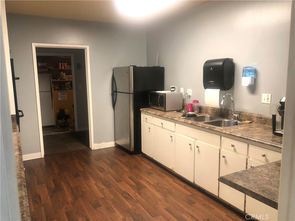 1560 Massachusetts Avenue, Unit 46 Riverside, CA 92507 - Photo 14 of 18 a kitchen with stainless steel appliances granite countertop a refrigerator and a sink