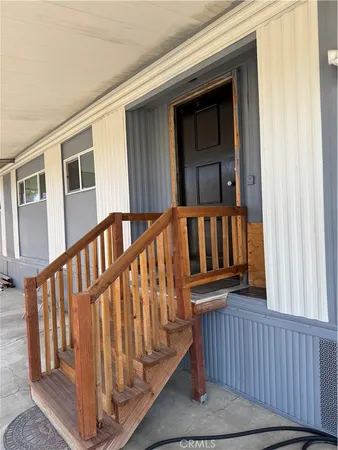 a view of a porch with furniture and next to a yard