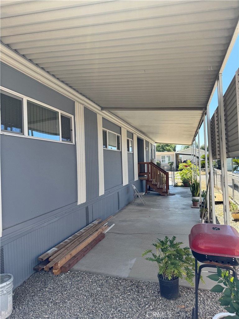 1560 Massachusetts Avenue, Unit 46 Riverside, CA 92507 - Photo 5 of 18 a view of a porch with furniture and next to a yard