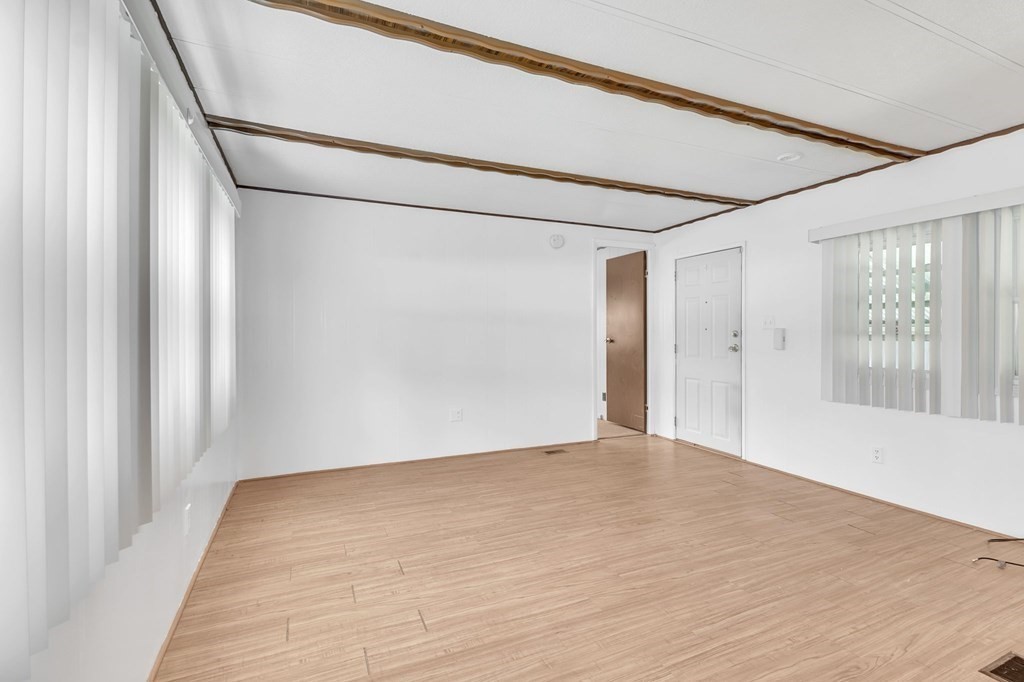 46 Contessa Lane Springfield, MA 01119 - Photo 12 of 25 a view of an empty room with wooden floor and a window