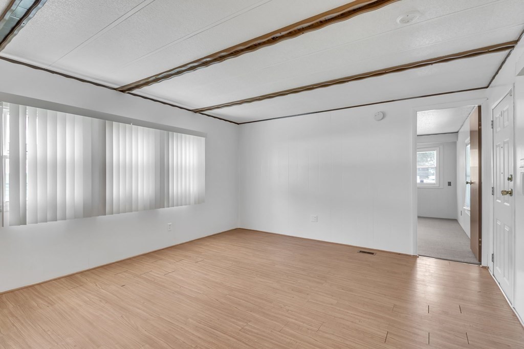 46 Contessa Lane Springfield, MA 01119 - Photo 13 of 25 a view of an empty room with wooden floor and a window