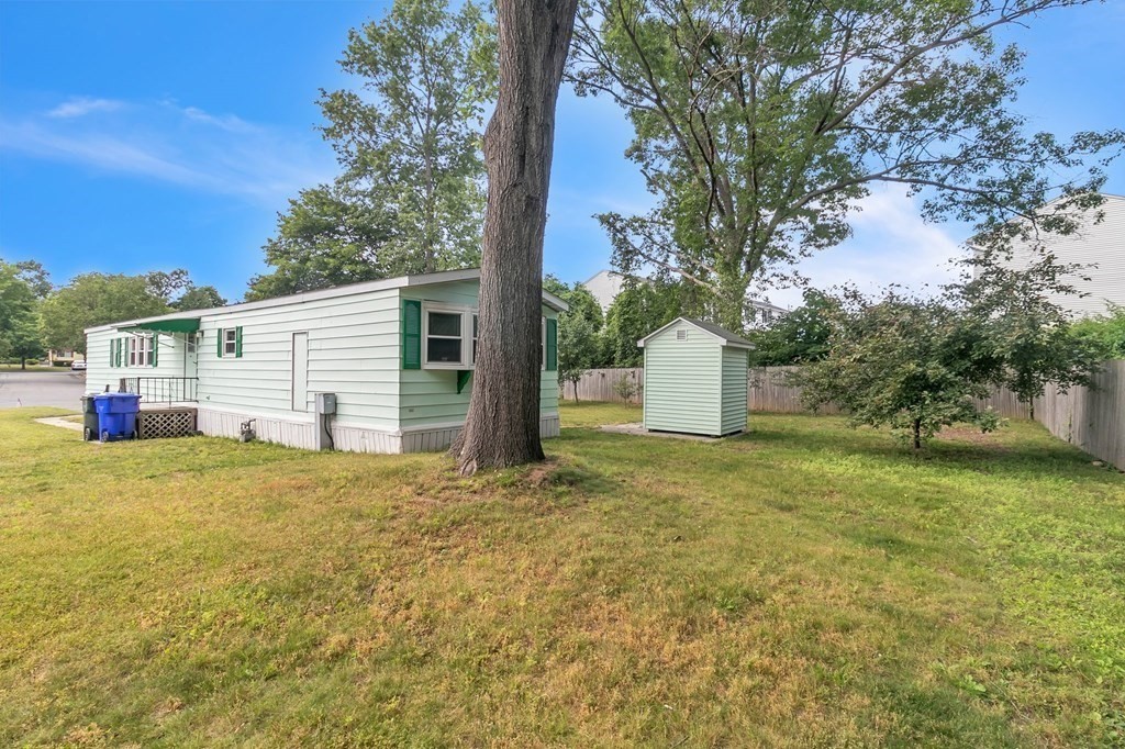 46 Contessa Lane Springfield, MA 01119 - Photo 2 of 25 a backyard of a house with plants and large tree