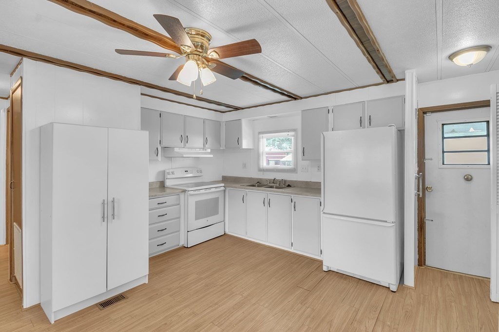 46 Contessa Lane Springfield, MA 01119 - Photo 6 of 25 a kitchen with white cabinets and white appliances