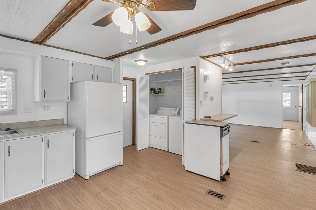 46 Contessa Lane Springfield, MA 01119 - Photo 7 of 25 a kitchen with a refrigerator a sink and cabinets