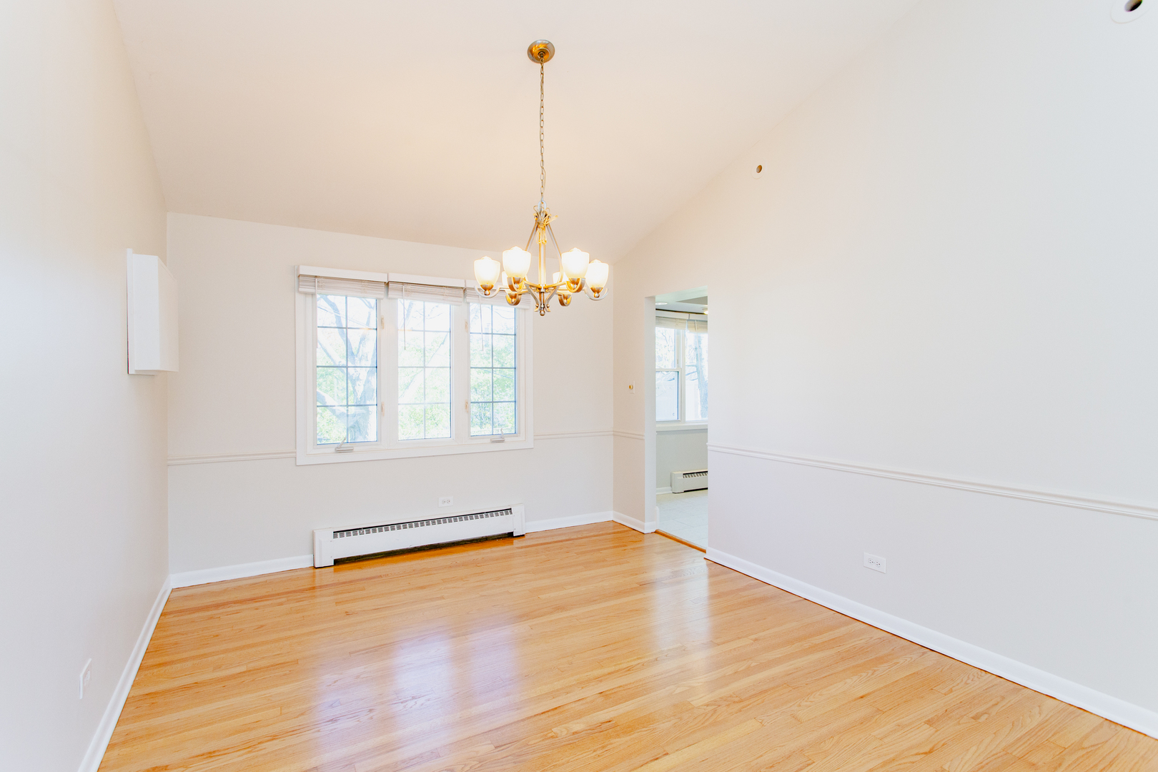 1503 Executive Lane Glenview, IL 60026 - Photo 12 of 40 a view of an empty room with chandelier and a window