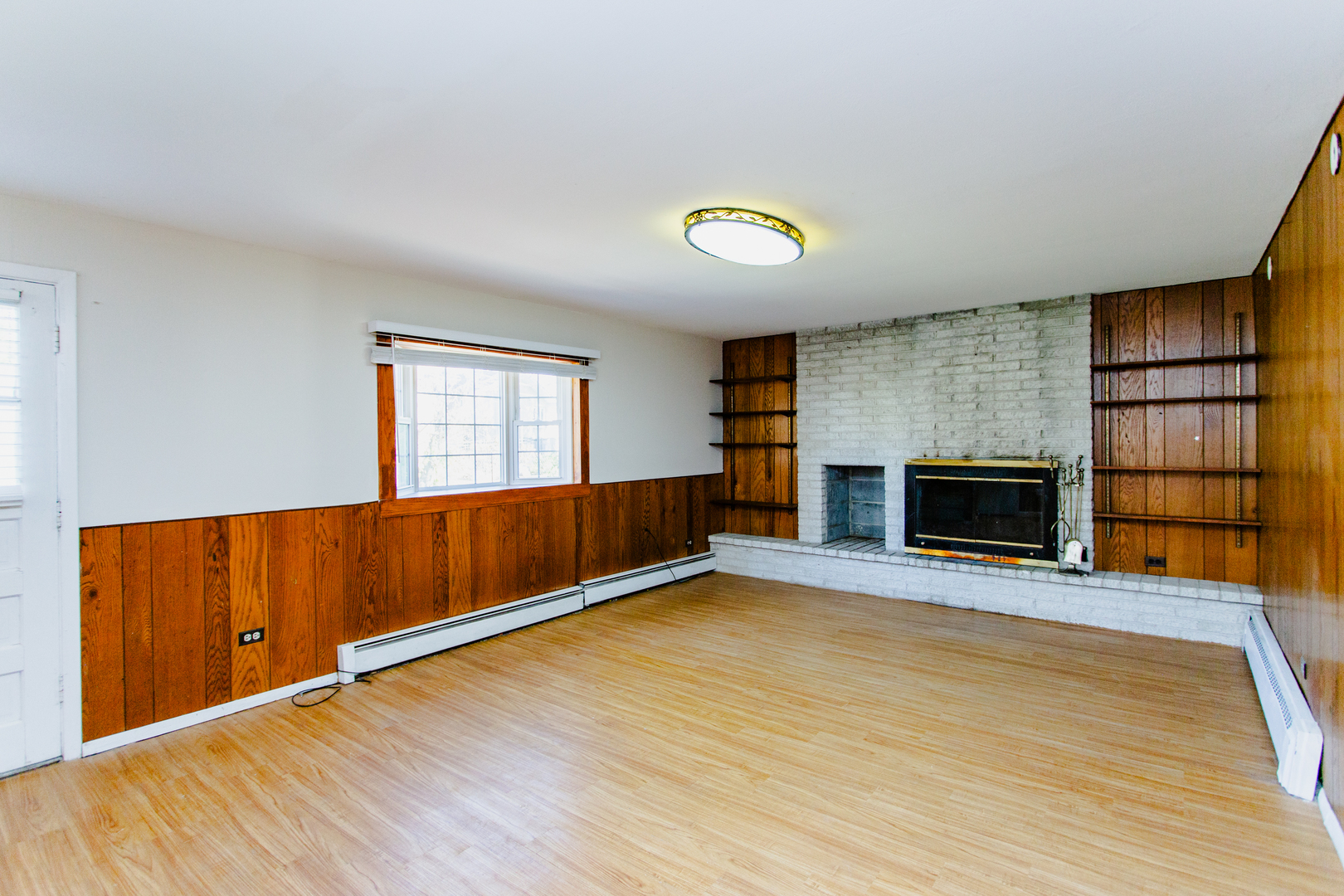 1503 Executive Lane Glenview, IL 60026 - Photo 16 of 40 an empty room with wooden floor and fireplace