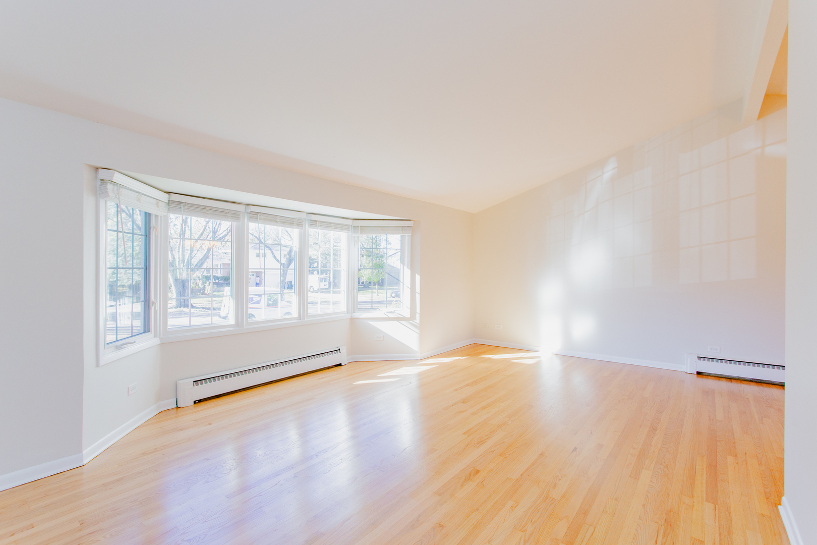 1503 Executive Lane Glenview, IL 60026 - Photo 10 of 40 a view of an empty room with wooden floor and a window