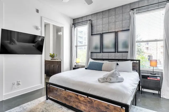 a bathroom with a granite countertop sink and a toilet