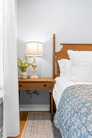 a bedroom with bed and window