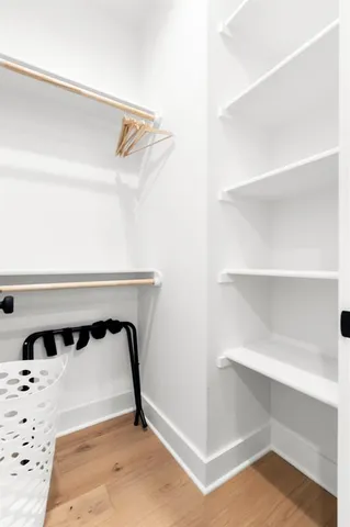 a bed sitting in a bedroom next to a window