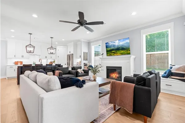 a living room with furniture a fireplace and a flat screen tv