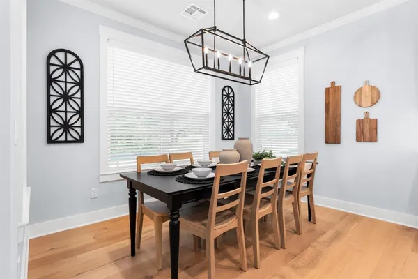a view of a dining room with furniture window and wooden floor