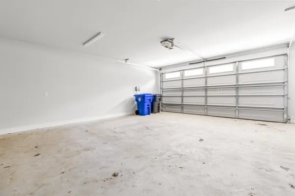 a view of a hallway with wooden floor and windows